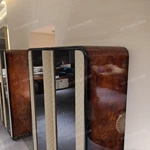 Rounded-Corner Dark Wood Wine Cabinet with Tinted Glass Doors Quilted Beige Upholstered Panels and Interior Shelving